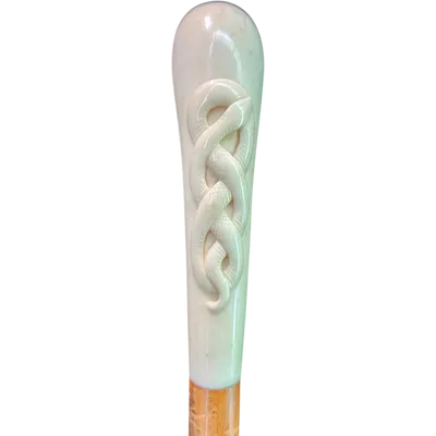 Cane with a spherical ivory knob featuring an intertwined snake engraved in high relief