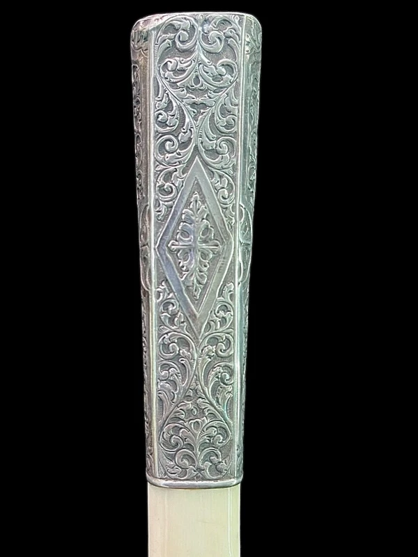 An ivory "evening" cane with tips and embossed silver featuring rocaille motifs