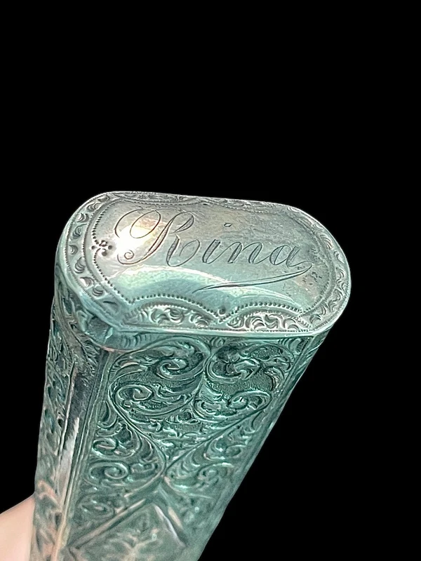 An ivory "evening" cane with tips and embossed silver featuring rocaille motifs