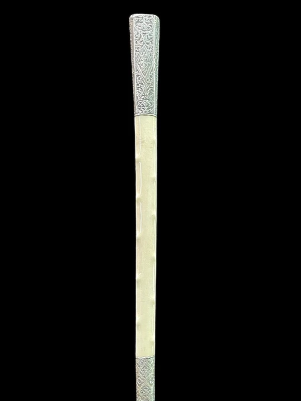 An ivory "evening" cane with tips and embossed silver featuring rocaille motifs
