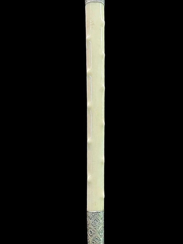 An ivory "evening" cane with tips and embossed silver featuring rocaille motifs