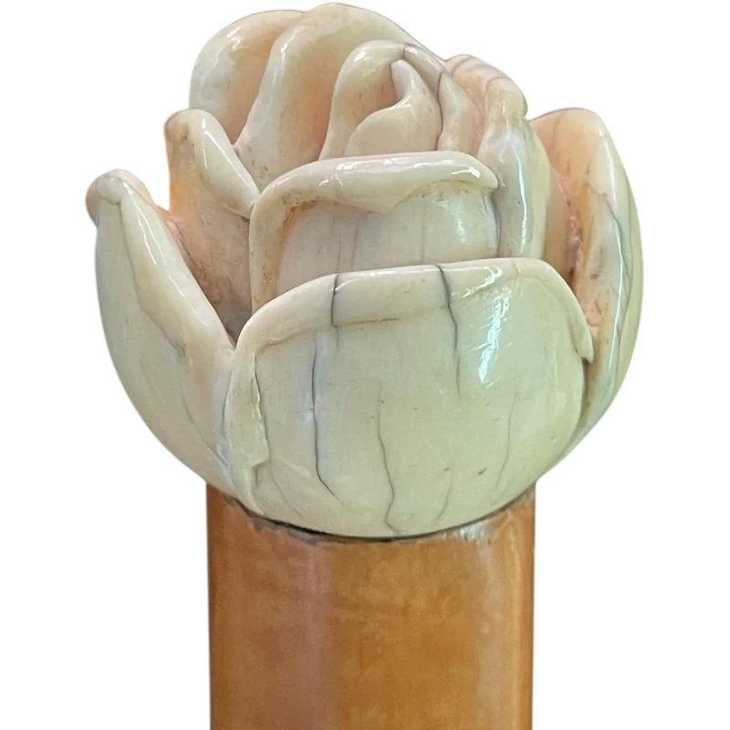 A walking stick with an ivory knob depicting a rose.