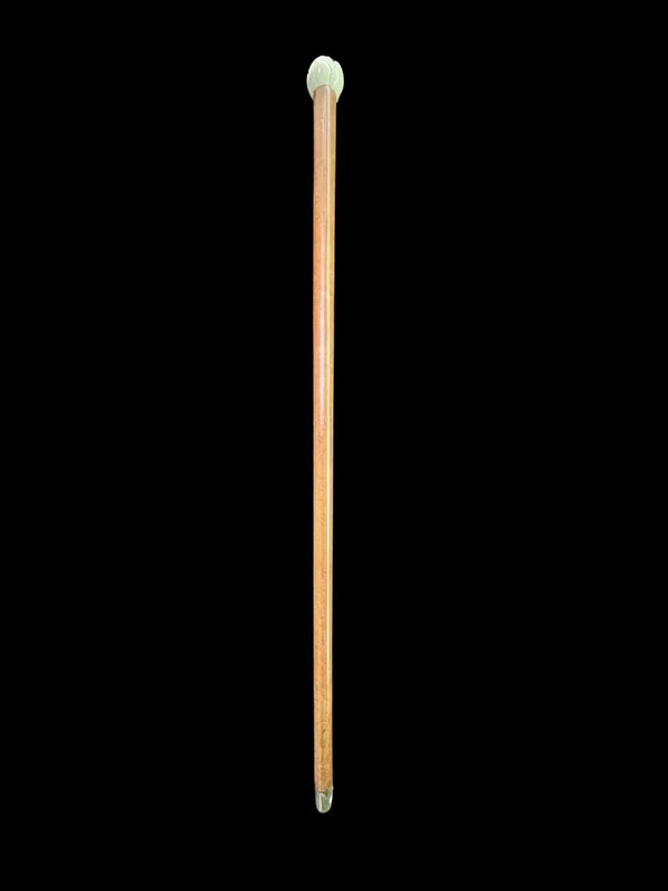 A walking stick with an ivory knob depicting a rose.