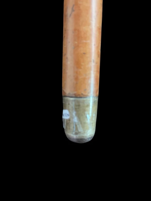 A walking stick with an ivory knob depicting a rose.