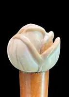 A walking stick with an ivory knob depicting a rose.