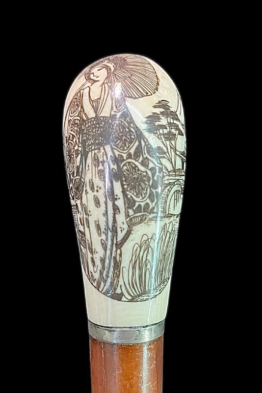 Cane with a spherical ivory knob on one side, engraved with a female figure