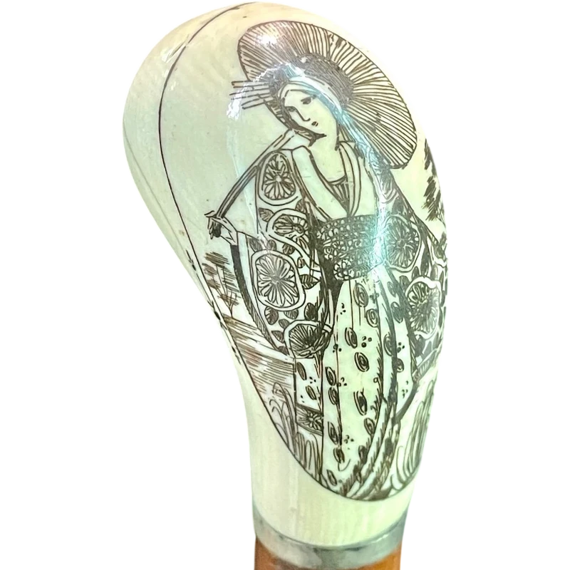 Cane with a spherical ivory knob on one side, engraved with a female figure