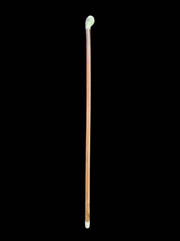 Cane with a spherical ivory knob on one side, engraved with a female figure