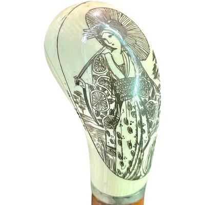Cane with a spherical ivory knob on one side, engraved with a female figure