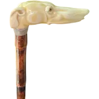 A cane with a side handle made of ivory in the shape of a greyhound's head.