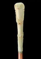 A walking stick with a vertical, curved ivory knob engraved with floral garlands and rocaille motifs.