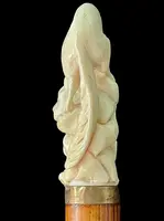 A walking stick with an ivory pommel depicting a wolf hunting prey hidden in a cave.