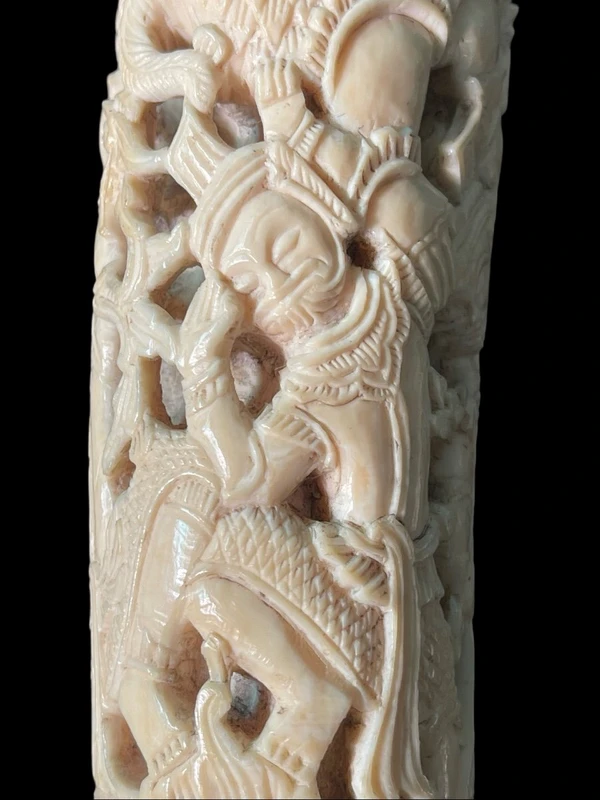 Cane with an ivory knob carved with figures and plant motifs; bamboo shaft.