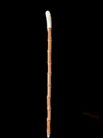 Cane with an ivory knob carved with figures and plant motifs; bamboo shaft.