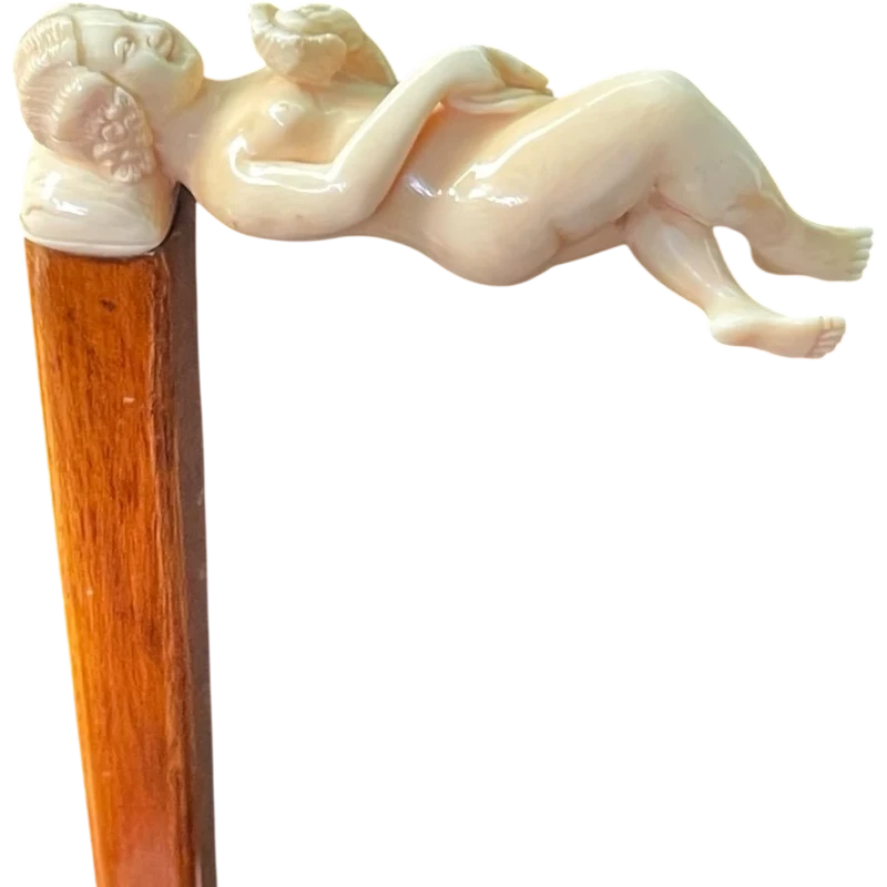 A walking stick with an ivory handle featuring an erotic motif of a reclining female figure.