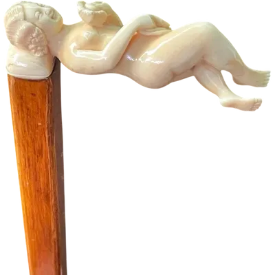 A walking stick with an ivory handle featuring an erotic motif of a reclining female figure.