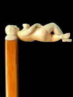 A walking stick with an ivory handle featuring an erotic motif of a reclining female figure.