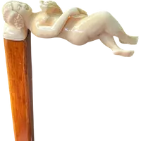 A walking stick with an ivory handle featuring an erotic motif of a reclining female figure.