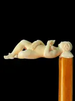 A walking stick with an ivory handle featuring an erotic motif of a reclining female figure.