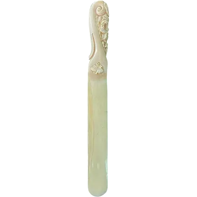 A one-piece ivory letter opener engraved with floral and rocaille motifs.