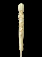 A one-piece ivory letter opener engraved with floral and rocaille motifs.
