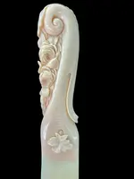 A one-piece ivory letter opener engraved with floral and rocaille motifs.