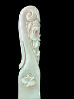 A one-piece ivory letter opener engraved with floral and rocaille motifs.
