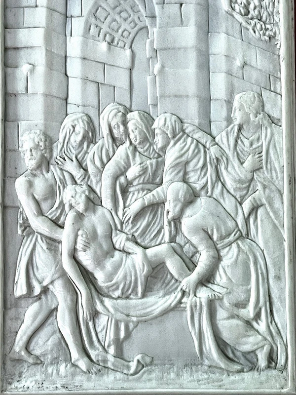 A low-relief ivory sculpture on a thin sheet of metal depicting the Entombment of Christ.