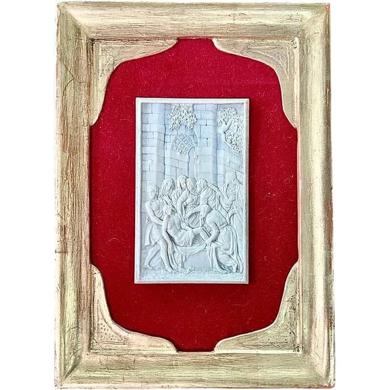 A low-relief ivory sculpture on a thin sheet of metal depicting the Entombment of Christ.