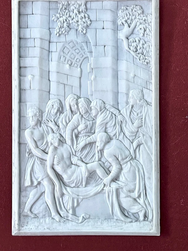A low-relief ivory sculpture on a thin sheet of metal depicting the Entombment of Christ.