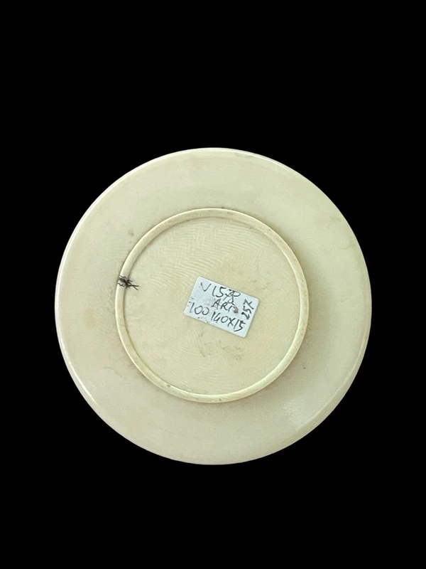 A small ivory box with monkeys engraved on the lid.