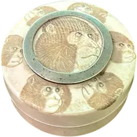 A small ivory box with monkeys engraved on the lid.