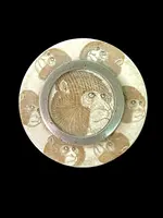 A small ivory box with monkeys engraved on the lid.