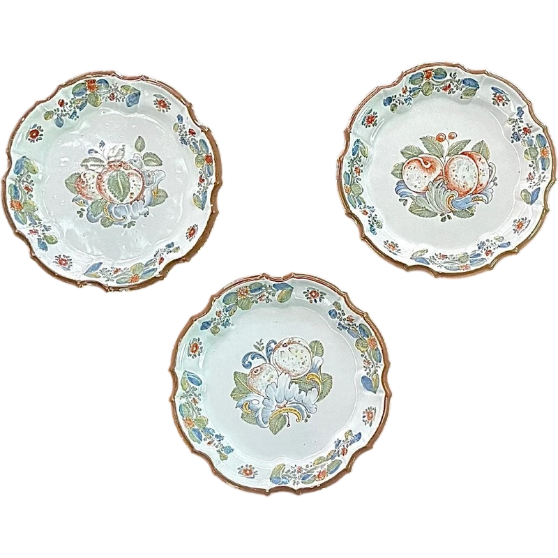 Three majolica plates with scalloped rims and high-fire “Baroque fruit” decoration.