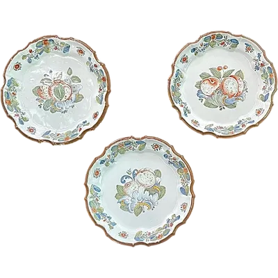 Three majolica plates with scalloped rims and high-fire “Baroque fruit” decoration.