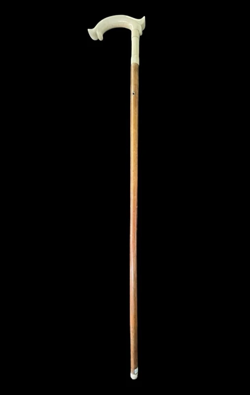 Cane with an ivory tau-shaped handle featuring a stylized rocaille motif.