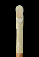 Cane with an ivory tau-shaped handle featuring a stylized rocaille motif.