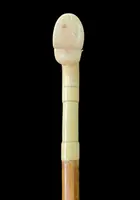 Cane with an ivory tau-shaped handle featuring a stylized rocaille motif.