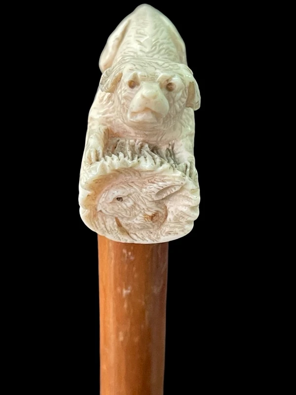 A walking stick with an ivory side handle depicting a dog hunting a hare.