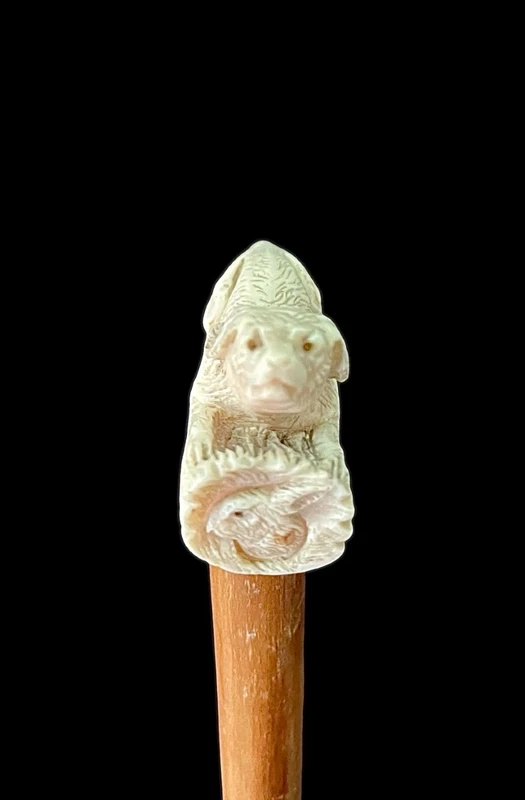 A walking stick with an ivory side handle depicting a dog hunting a hare.