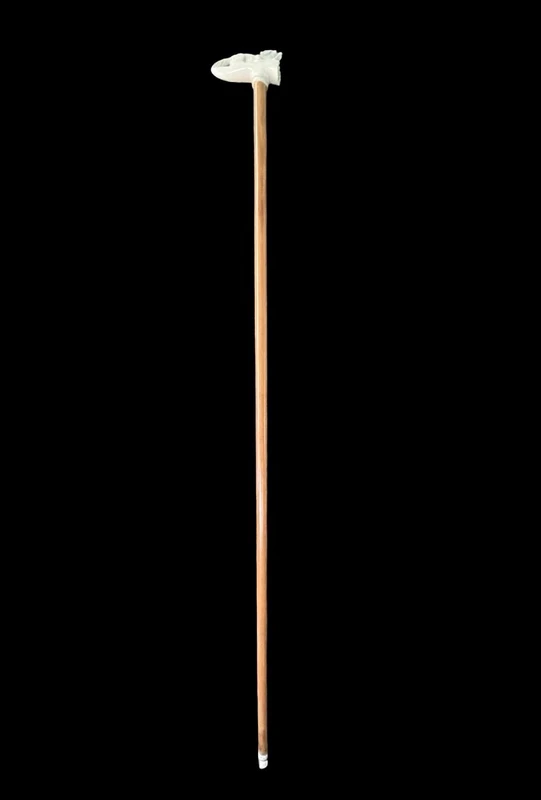 A walking stick with an ivory side handle depicting a dog hunting a hare.