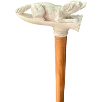 A walking stick with an ivory side handle depicting a dog hunting a hare.