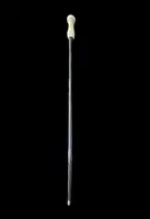 An evening cane with an ivory knob featuring a relief shield and rocaille motifs.