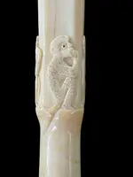 An evening cane with a square-section ivory knob featuring three monkeys engraved in bas-relief.