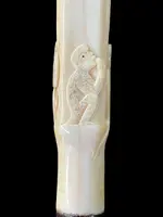 An evening cane with a square-section ivory knob featuring three monkeys engraved in bas-relief.