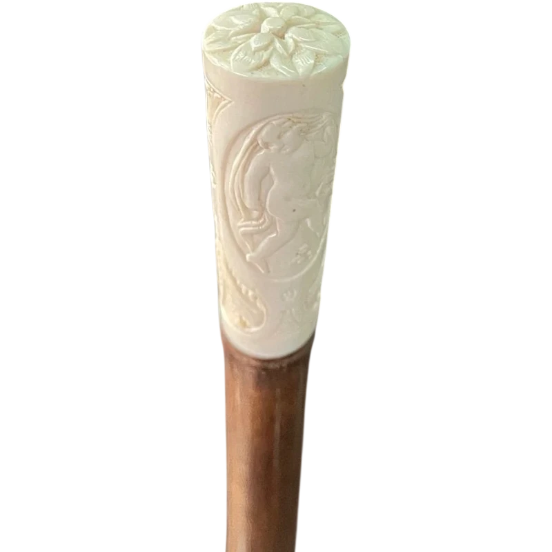 Cane with an ivory "plume" knob featuring cherubs engraved within three ovals