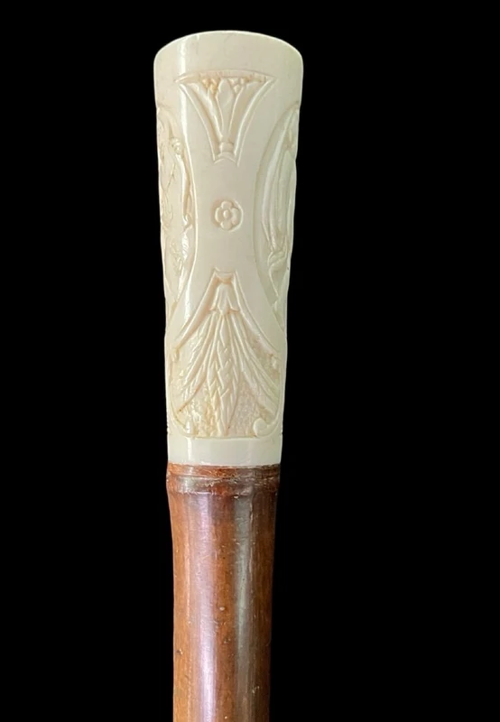 Cane with an ivory "plume" knob featuring cherubs engraved within three ovals