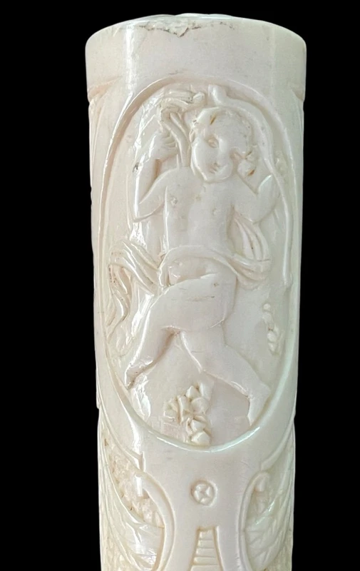 Cane with an ivory "plume" knob featuring cherubs engraved within three ovals