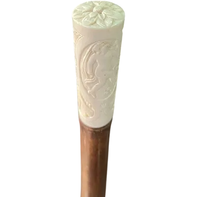 Cane with an ivory "plume" knob featuring cherubs engraved within three ovals