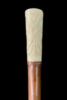 Cane with an ivory "plume" knob featuring cherubs engraved within three ovals
